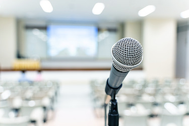 Photos of microphones lined up on a long table 
