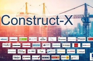 Photo of a city with construction cranes.   