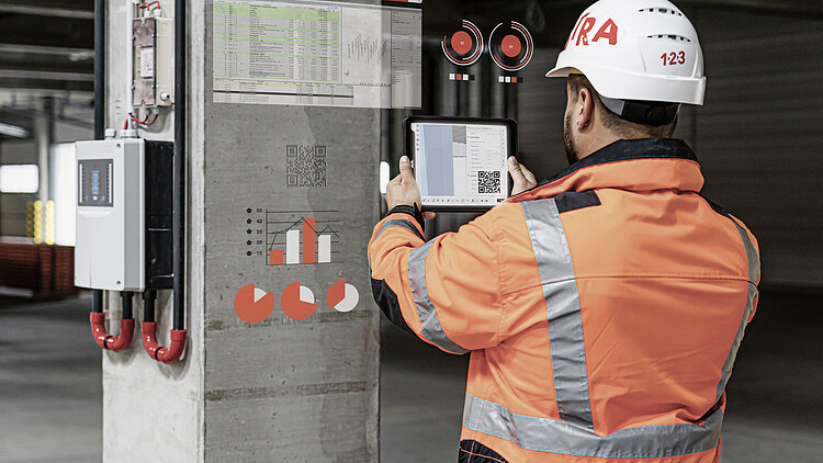 STRABAG employee with technical aids