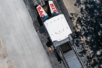 A bird's eye view of a machine laying asphalt