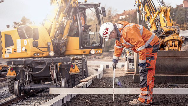 Photo of station tracks and construction workers working there